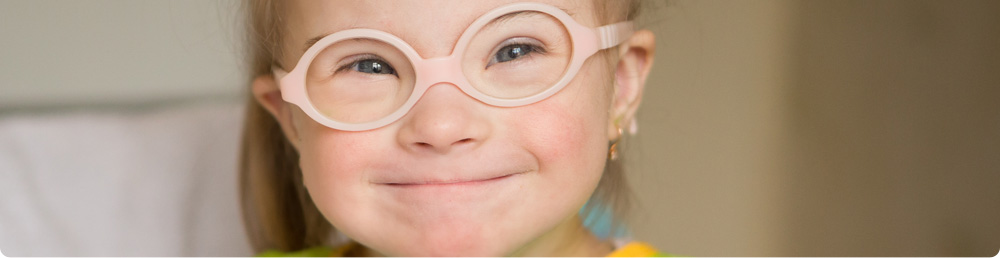 A young child wearing fake plastic glasses.